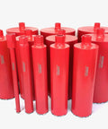 Straight Shooting Heavy Duty Workhorse Diamond Coring Drill With Tilting Rolling Base And Killer 12 Piece Wet Core Bit Set Pro Concrete Cutting Setup 110 Volt Dual Speed 2600 Watt Motor Crushes 12 Inch Cuts featuring red diamond core bits.