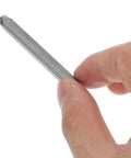 Close-up of hand holding a steel punch from 37 Piece Metal Stamping Kit With A to Z Alphabet Letters Numbers And Heart Symbols For Wood Plastic