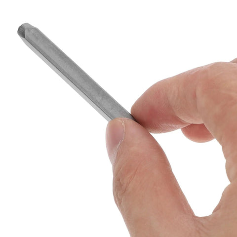 Close-up of hand holding a steel punch from 37 Piece Metal Stamping Kit With A to Z Alphabet Letters Numbers And Heart Symbols For Wood Plastic