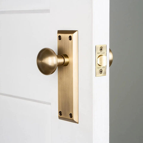 New York Plate And Homestead Door Knob Set With Oval Knob And Long Back Plate In Dope Finishes For A Classic Vintage Look