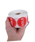 Hand holding roll of Red Round Self Adhesive Sold Stickers Two Inch Paper Labels For Retail Store And Warehouse Inventory Control Pricing Supplies 500 Pack With Strong Adhesion And Uniform Appearance For Clear Tagging And Easy Price Updates