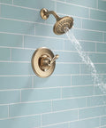 Linden 14 Series Shower Trim Kit With 5 Spray Touch Clean Shower Head in Venetian Bronze installed on blue tile wall.
