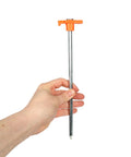 Person holding Beefy 10-Inch Steel Tent Stakes Heavy-Duty Ground Anchors 4-Pack for Camping with orange handle