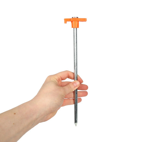 Person holding Beefy 10-Inch Steel Tent Stakes Heavy-Duty Ground Anchors 4-Pack for Camping with orange handle