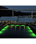 Top Shelf Green Dock Light And Fishing Lantern Waterproof Marine Grade Adjustable Bright Illumination For Nighttime Angling Crew Favorite Solid Deck Upgrade Package illuminating dock area at night with green lights.