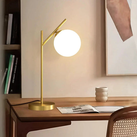 Mid Century Modern Table Lamp With Brass Metal Body And Milky White Glass Globe Shade 1 Light Bedside Lamp on wooden desk