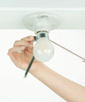 Hand attaching clip-on Ceiling Light Cover That Hides Exposed Bulbs In Seconds Clip-On Fit For Most Bulbs And Fixtures Sleek Modern 2 Pack