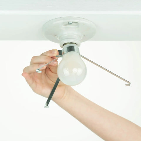 Hand attaching clip-on Ceiling Light Cover That Hides Exposed Bulbs In Seconds Clip-On Fit For Most Bulbs And Fixtures Sleek Modern 2 Pack