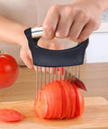 5-blade vegetable slicer with black handle, slicing a tomato into rounds on a cutting board