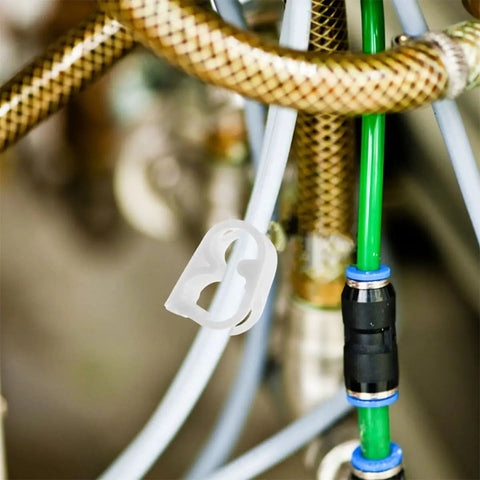 White Adjustable Plastic Tube Flow Control Clamps For Lab And Home Brew Pinch Valves attached to tubing