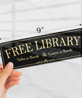 Acrylic 9x3 Inch Free Library Sign Self Stick Door Wall Signage for DIY Projects, Royal Black Finish, shown in a hand.