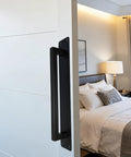 Heavy Duty 10 Inch Sliding Door Handle In Matte Black Stainless Steel Surface Mount For Gate Patio Barn Door attached to a white door.