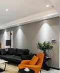 Living room featuring saditesdk 3.3 Inch Led Directional Recessed Light illuminating a modern decor with an orange chair.