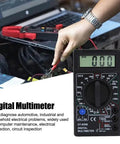 Pocket Size Digital Multimeter With LCD Auto Range for voltage testing in automotive diagnostics, shows hand using meter