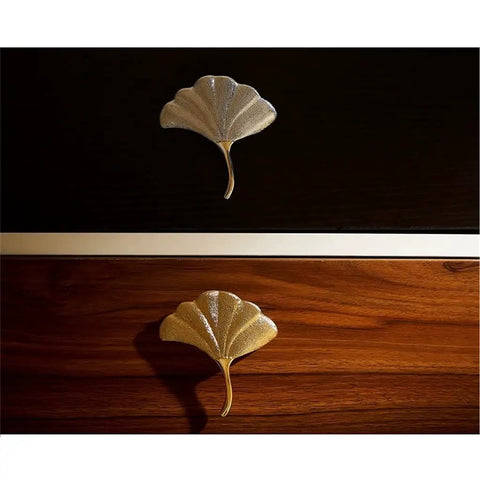 Slick Brass Cabinet Handle With Fresh Modern Nordic Vibe Sturdy Electroplated Furniture Knobs For Drawers Doors on dark and light wood.
