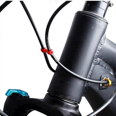 Multipurpose Alloy Bicycle Brake Line Clamps And Cable Clips For Road Bikes No Tool Needed Easy Install Cable Management Secure Grip Anti Loosening Support Universal Bike Accessories For Wires And Cables installed on bike frame, securing cables in place.