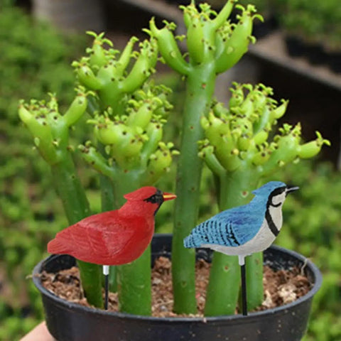 Simulated Bird Shaped Soil Moisture Sensor With Automatic Alarm in garden pot with green plants