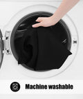 Hand placing 4 Pack Rectangle Picnic Table Cloths With Elastic Fitted Edges For A No Slip Waterproof And Spillproof Setup into a washing machine.