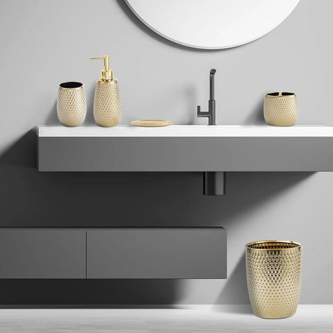 Golden Modern Small Trash Can Wastebasket For Bathrooms Powder Rooms Kitchens And Home Offices Durable Ceramic Round Garbage Container Bin Compact Space Saving Design That Fits Under Sinks Cabinets Or On Counters next to a sink in a modern bathroom.