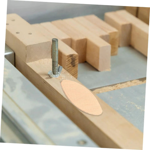 Close-up of 100 Pcs Wood Joiner Biscuits Set for Woodworking Projects, showing biscuit in wood slot.