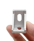 Close-up of a 90-degree aluminum extrusion corner bracket for 1.5 inch profile rails, part of 20 Sets Of 1.5 Inch Aluminum Extrusion Corner Brackets With T Nuts And Bolts, Built To Last For 3D Printers, CNC Routers, And Robotic Frames.