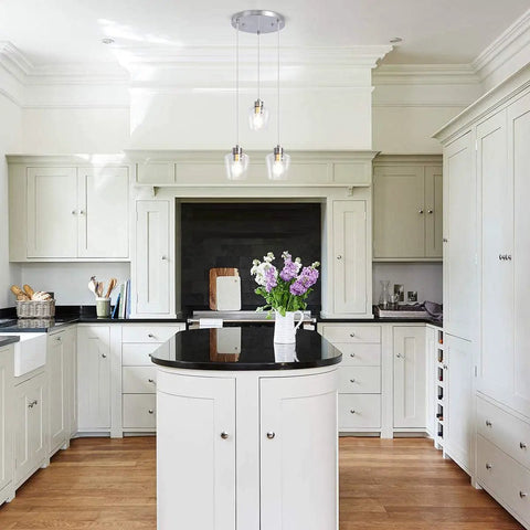 Three Light Pendant Lighting With Clear Glass And Adjustable Silver Cord In Brushed Nickel installed over kitchen island