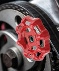 Close-up of red cast iron 7x7mm gate valve shutoff handle for industrial valve control, showing flat bottom design on metal ball hand wheel.