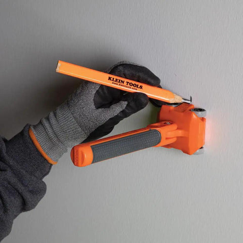 Hand using Pro Grade Magnetic Wire Puller For Behind Walls And Tight Spaces with Rare-Earth Magnets on gray wall.
