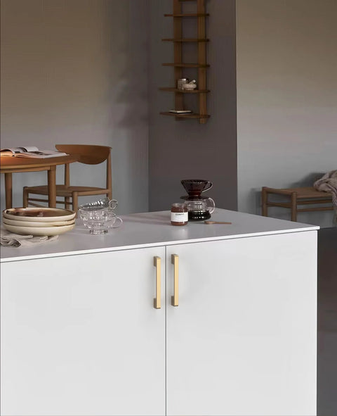 Elegant kitchen scene with Pack Of 10 Five Inch Center To Center Zinc Alloy Kitchen Cabinet Handles In Champagne Bronze Finish on white cabinets.