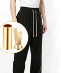 Close-up of gold alloy shoelace end caps used on black pants showing Gold Alloy Shoelace End Caps Set Of 36 With Screws Cylindrical Aglets For Shoes And Jackets Durable Metal Tips 18 X 7 Mm Replacement Laces Ends For Everyday Wear.