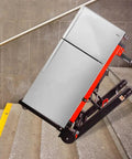 Heavy Duty Electric Hand Truck With 441 Lb Capacity And 160W Motor moving a refrigerator up stairs, demonstrating strength and design.