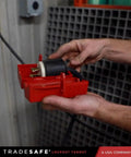 OSHA Compliant Electrical Lockout Tagout Kit With Hasps, showing hands using red plug lockout device for safety.