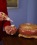Using Crystal Clear Super Glue Instant Bond Adhesive Hella Tough 20 Gram Bottle to repair decorative container.