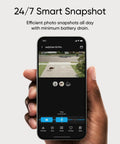 Hand holding smartphone displaying Top Tier Solar Outdoor Security Camera With 4K MaxColor Night Vision app interface.