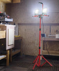 Two Pack 10000 Lumen Dual Head LED Work Light On Adjustable Foldable Tripod Stand in workshop setting