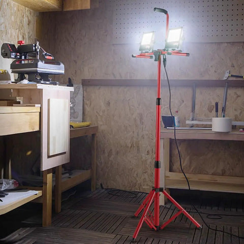 Two Pack 10000 Lumen Dual Head LED Work Light On Adjustable Foldable Tripod Stand in workshop setting