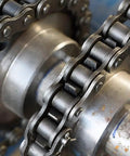 Close-up of a metal chain on a gear, used for heavy-duty machinery, ideal for Penetrating Lubricant For Metal Moving Parts, 17 Oz Can.
