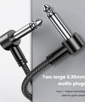 Close-up of three pack six inch guitar patch cables with right angle quarter inch TS connectors for pedalboard rig setup