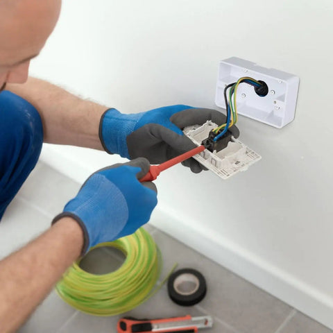 Person installing Five Piece Surface Mount Outlet Box Set Made From Durable ABS Plastic For Indoor Use on wall with tools.