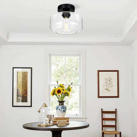 Industrial Dope Semi Flush Mount Ceiling Light In Matte Black With Clear Glass Shade above dining area.