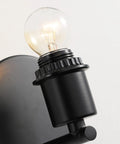Close-up of black base with bulb for Mid Century Bohemian Wall Sconce Lamp With Rattan Shade And Velvet Rim, Cozy Ambient Lighting.