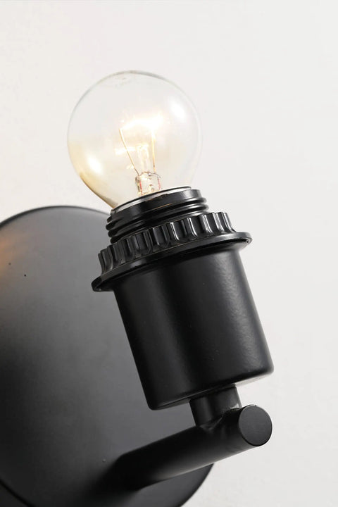 Close-up of black base with bulb for Mid Century Bohemian Wall Sconce Lamp With Rattan Shade And Velvet Rim, Cozy Ambient Lighting.