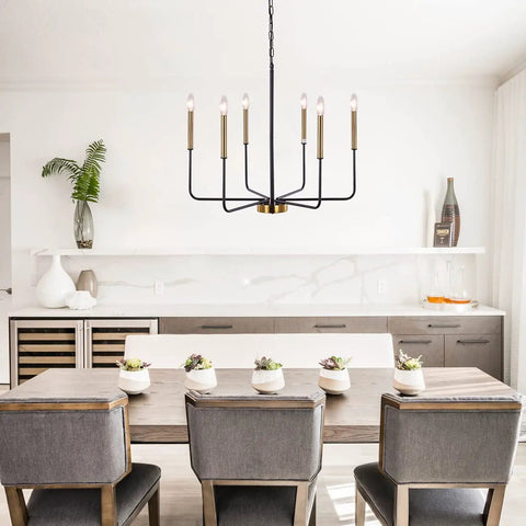 Six Light Farmhouse Chandelier in black and gold iron over dining table, showcasing candle style in modern dining room.