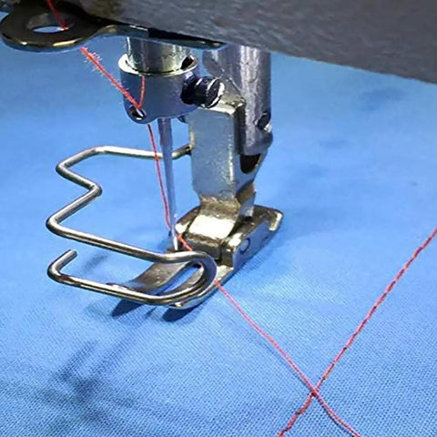 Close-up of a Six Pack Universal Iron Finger Guard installed on a sewing machine foot, protecting fingers while crafting.