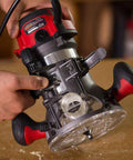 Heavy Duty 10 Amp Fixed Base Corded Router With A Beefy Two Point Zero Horsepower Motor And Variable Speed Control Built Tight For Smooth Woodworking Jobs That Get Done Right Today close-up view of adjustable router settings in use.