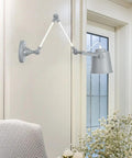 Real Deal Nordic Metal Swing Arm Wall Sconce Adjustable Task Light With Heavy Gauge Body E27 Compatible Easy Install For Bedroom Hallway Living Room Top Pick Gray White Finish mounted beside an armchair.