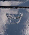 Close-up of a black powder-coated steel surface with embossed Viking logo on Beefy Clamp On Quick Spade Combo Blade For Tractor Buckets