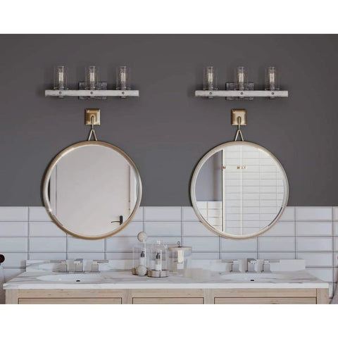 Gulliver Collection Three Light Clear Seeded Glass Coastal Bath Vanity Light in galvanized finish above dual mirrors and sinks.