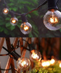 Outdoor String Lights 27 Clear G40 Bulbs On 25 Foot Black Wire Weatherproof Connectable Lighting illuminating greenery and wooden structure.