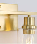 Close-up of 4 Light Gold Bathroom Vanity Light Fixture With Clear Glass Shades Brushed Brass Finish Modern Wall Sconce